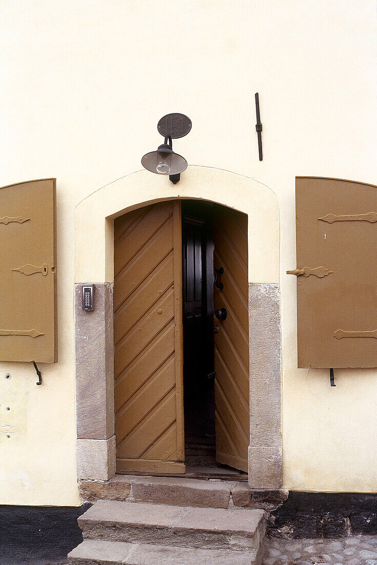 Detail of doorway with window shutters on either side Stockholm Sweden