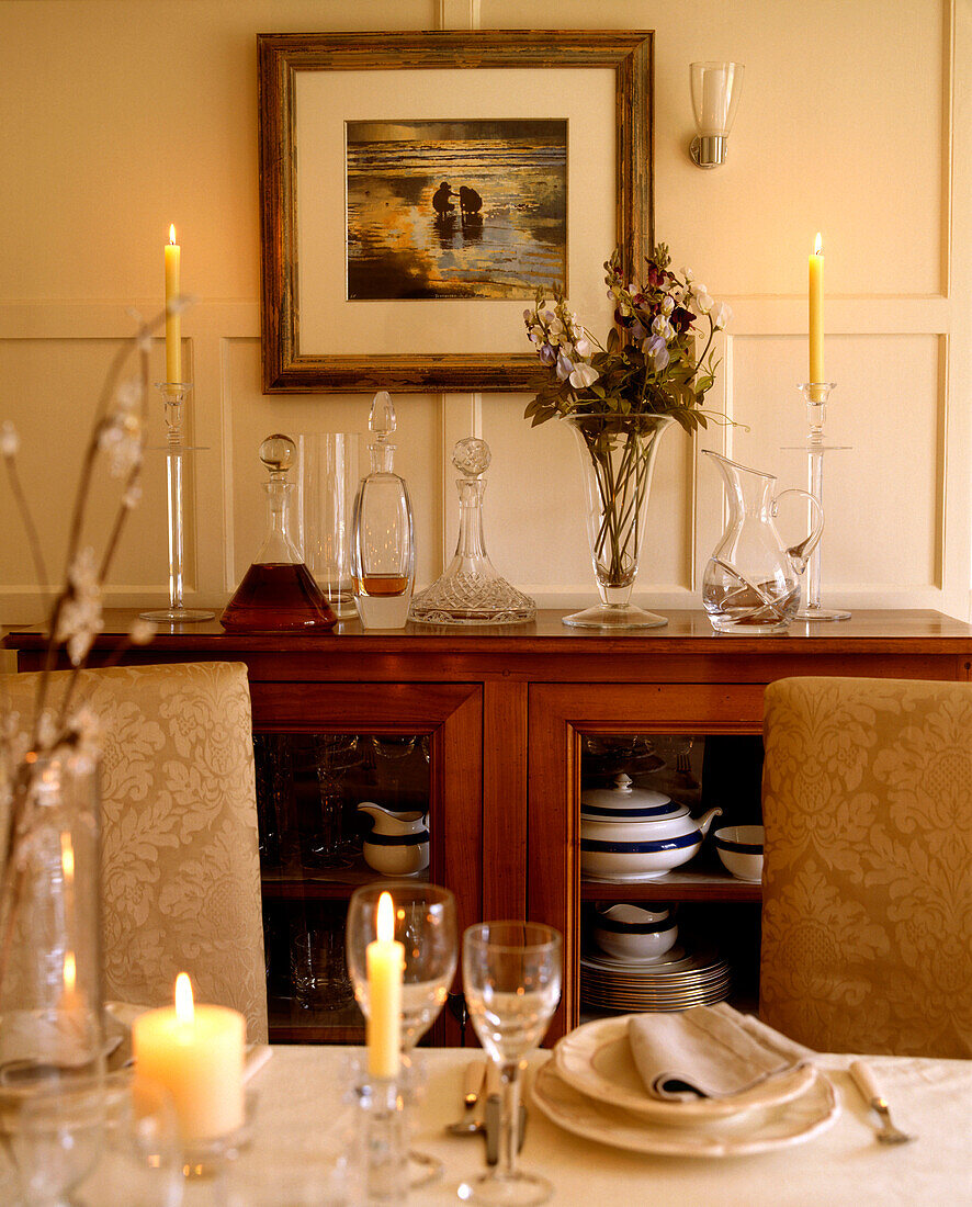 Detail of a set table and dining room cupboard