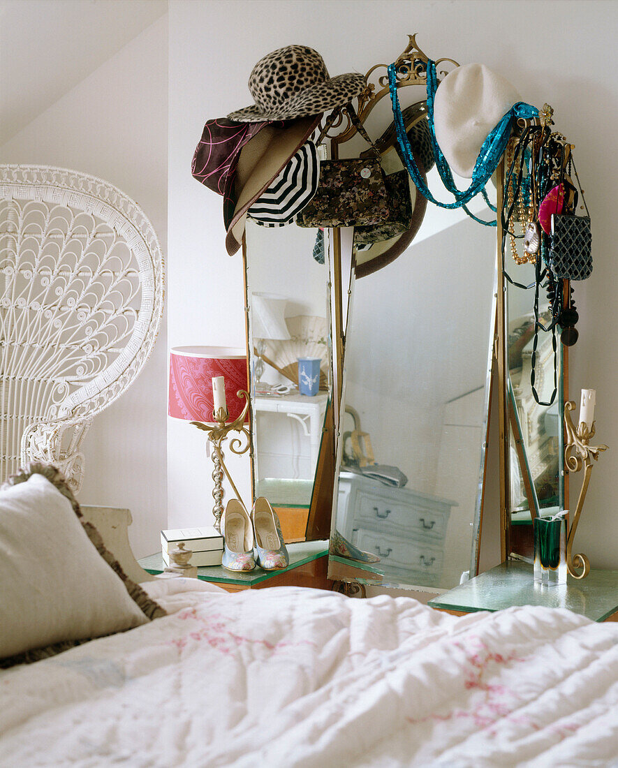 Dressing table mirror covered in collection of hats