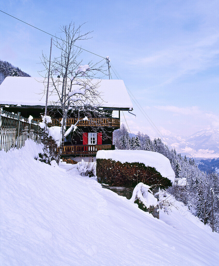 Exterior of snow covered Swiss chalet in mountains