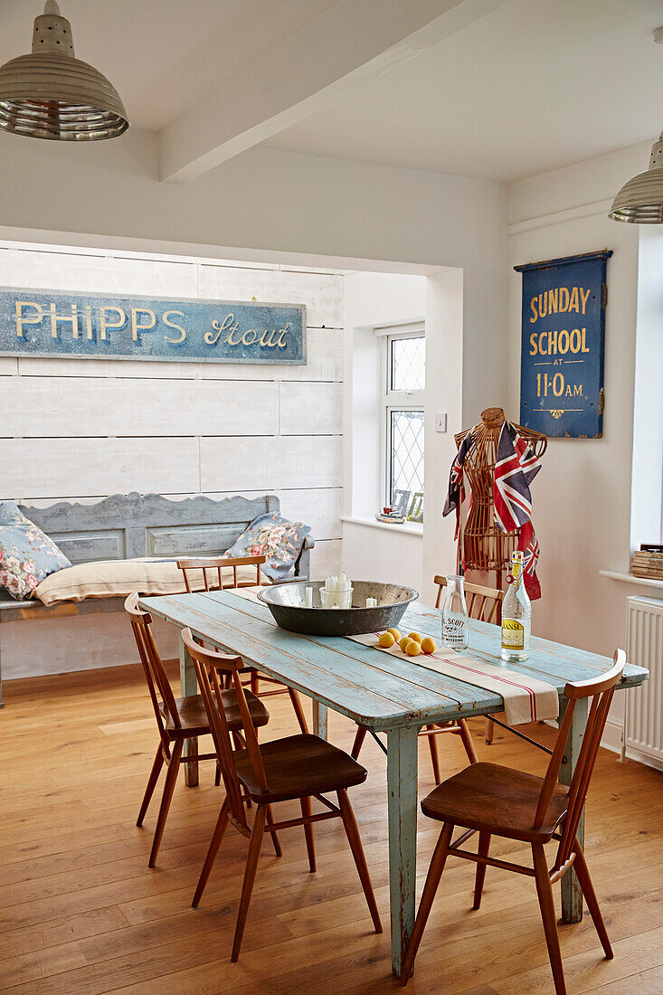 Wooden chairs at table with vintage signs in Shoreham by Sea, West Sussex, UK