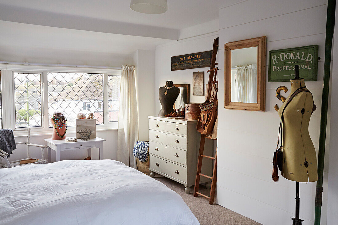 Dressmakers dummy and ladder with mirror on white bedroom with leaded glass windows Shoreham by Sea, West Sussex, UK