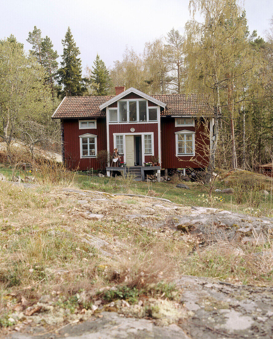 Exterior of a traditional wooden house on a wooded hillside