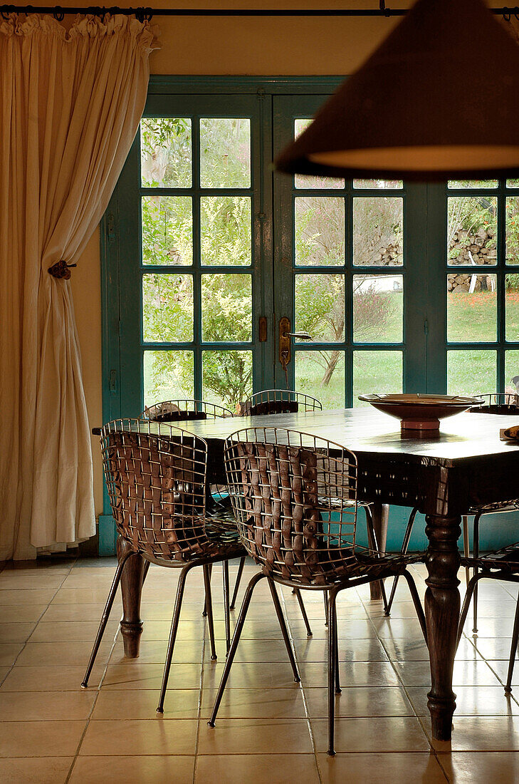 Dining room table with leather and metal woven chairs