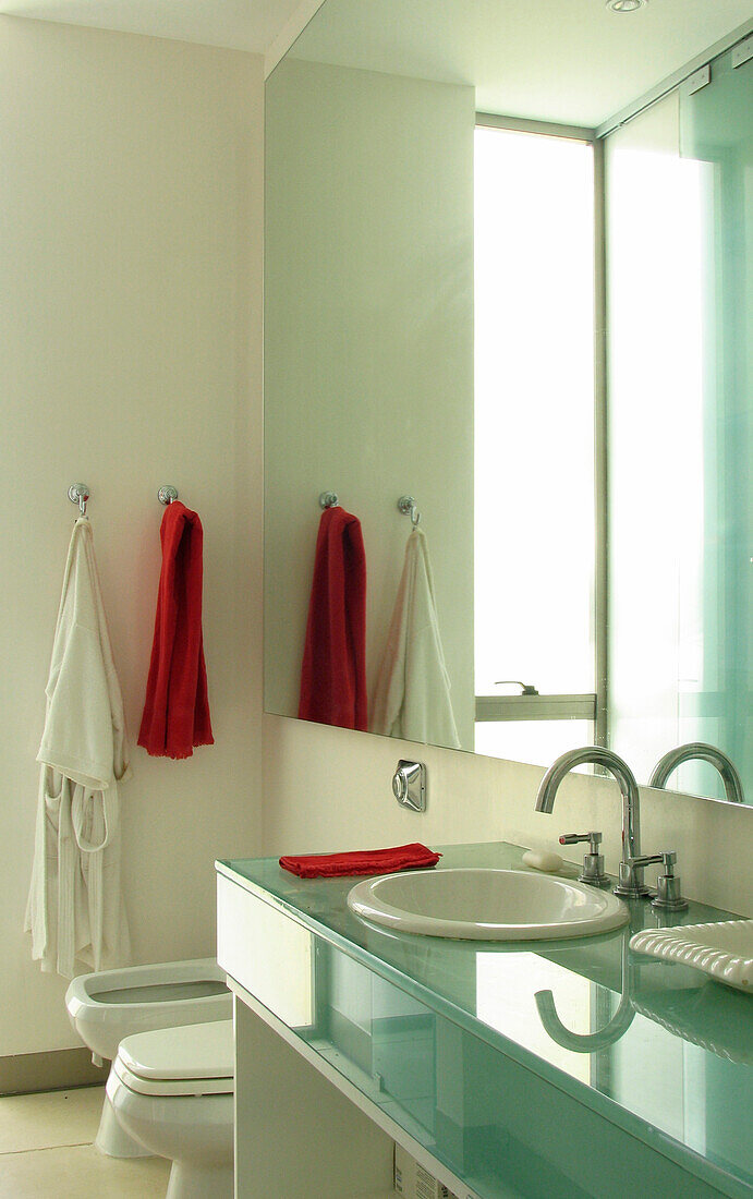 Minimalist bathroom design with glass and mirrors