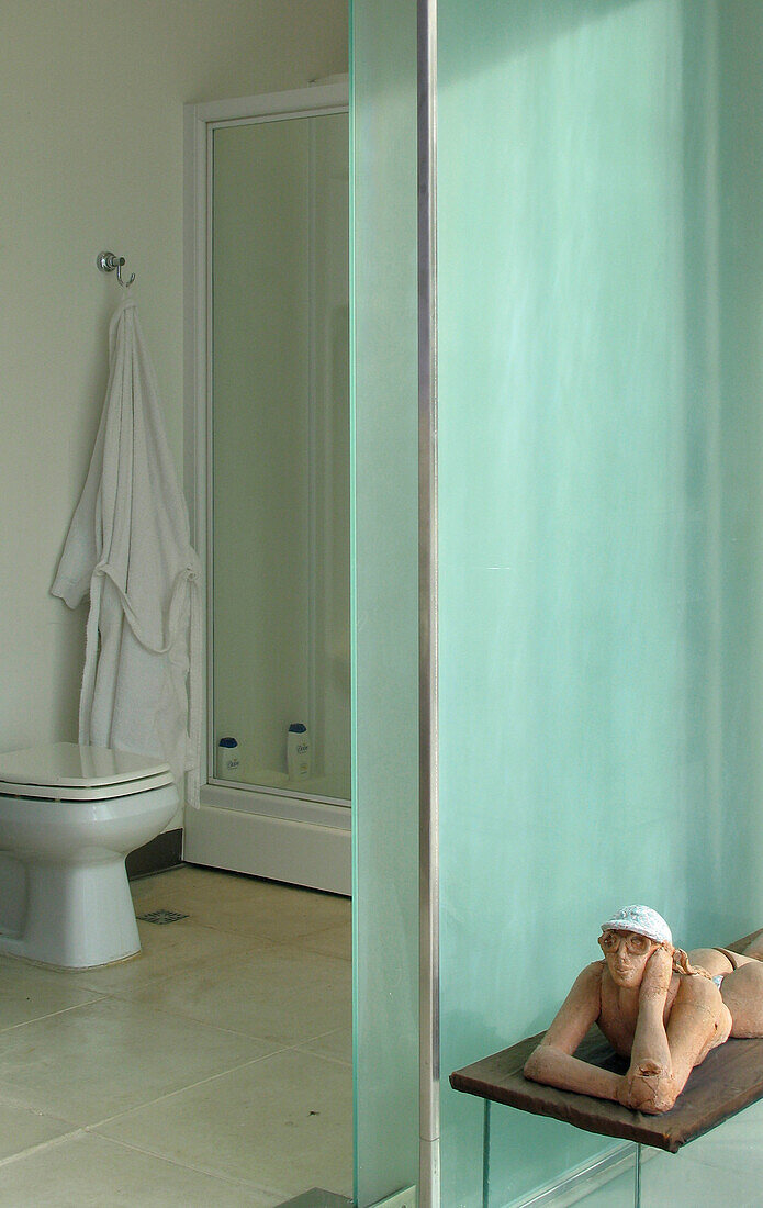 En suite bathroom with glass and mirrors