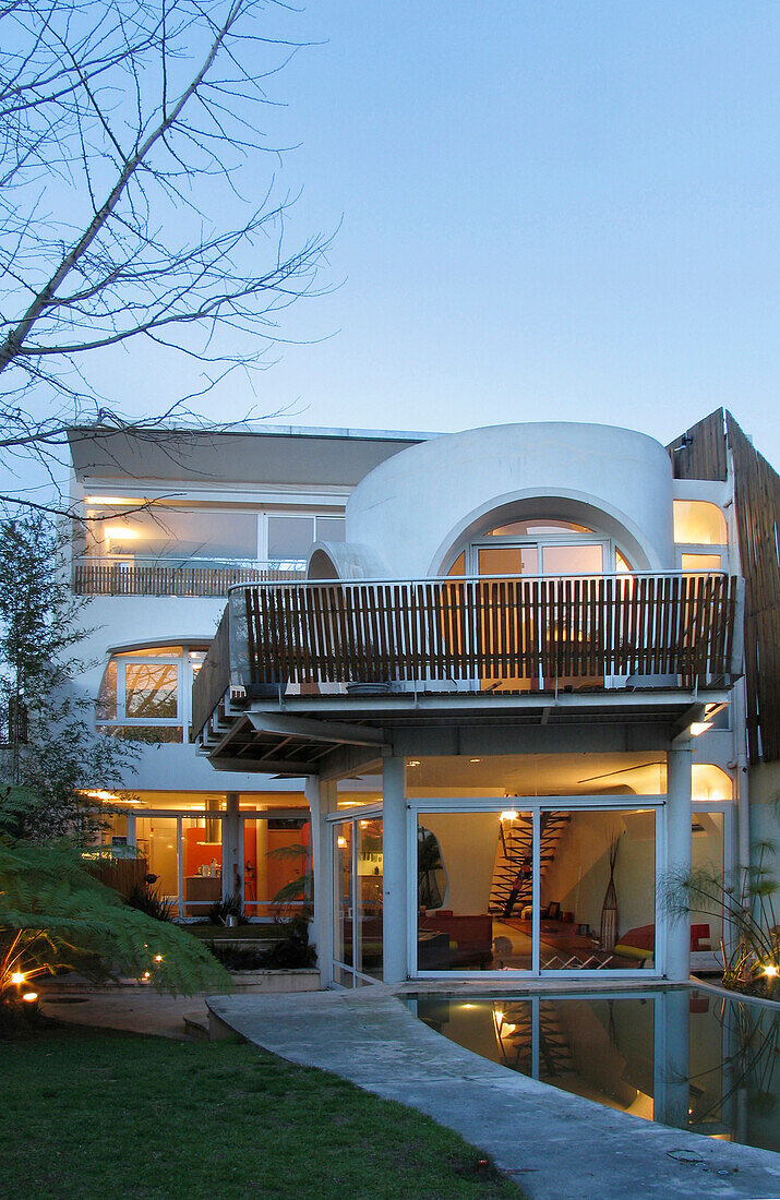 Modern facade stucco finished with white aluminium and windows in varying shapes