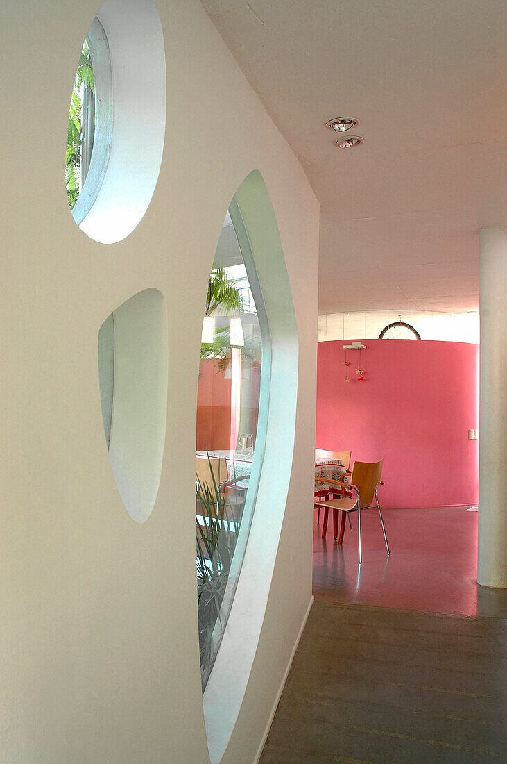 Smoothed concrete floor to dining room decorated in pink a colour which stimulate appetite