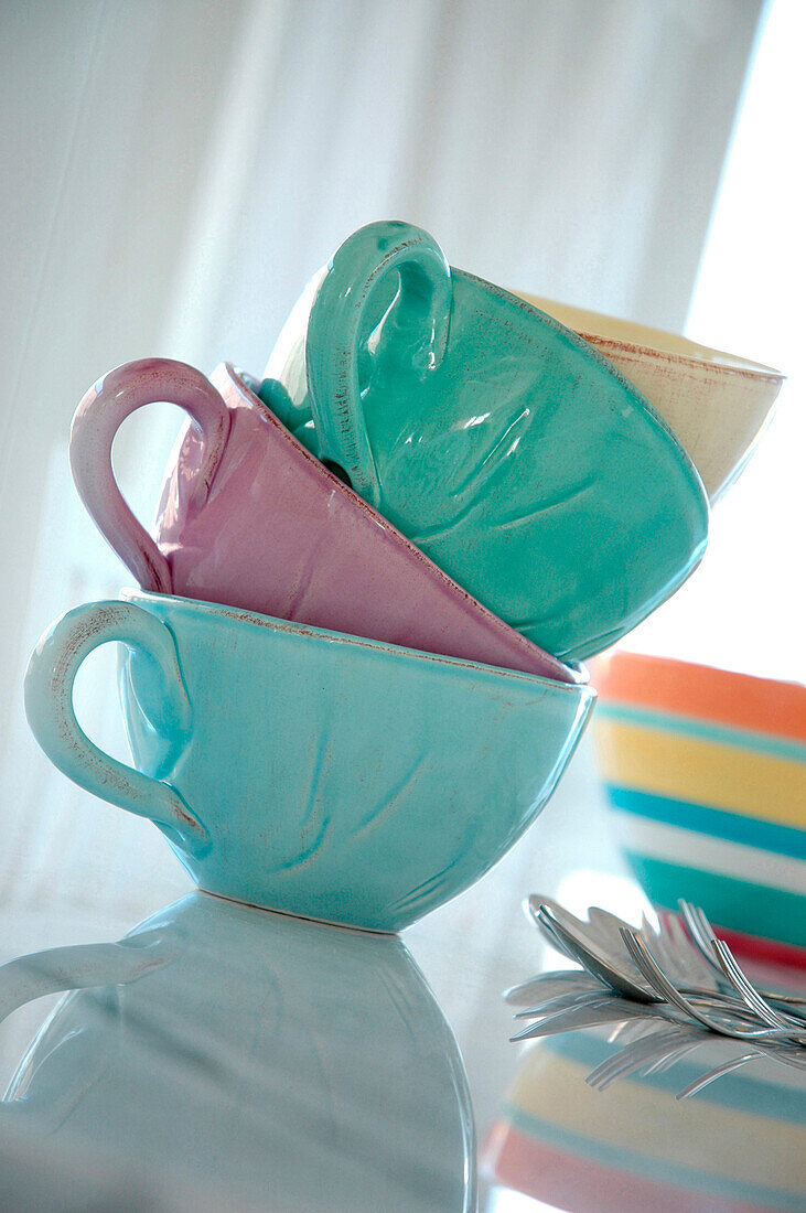 Pastel coloured teacups in a stack