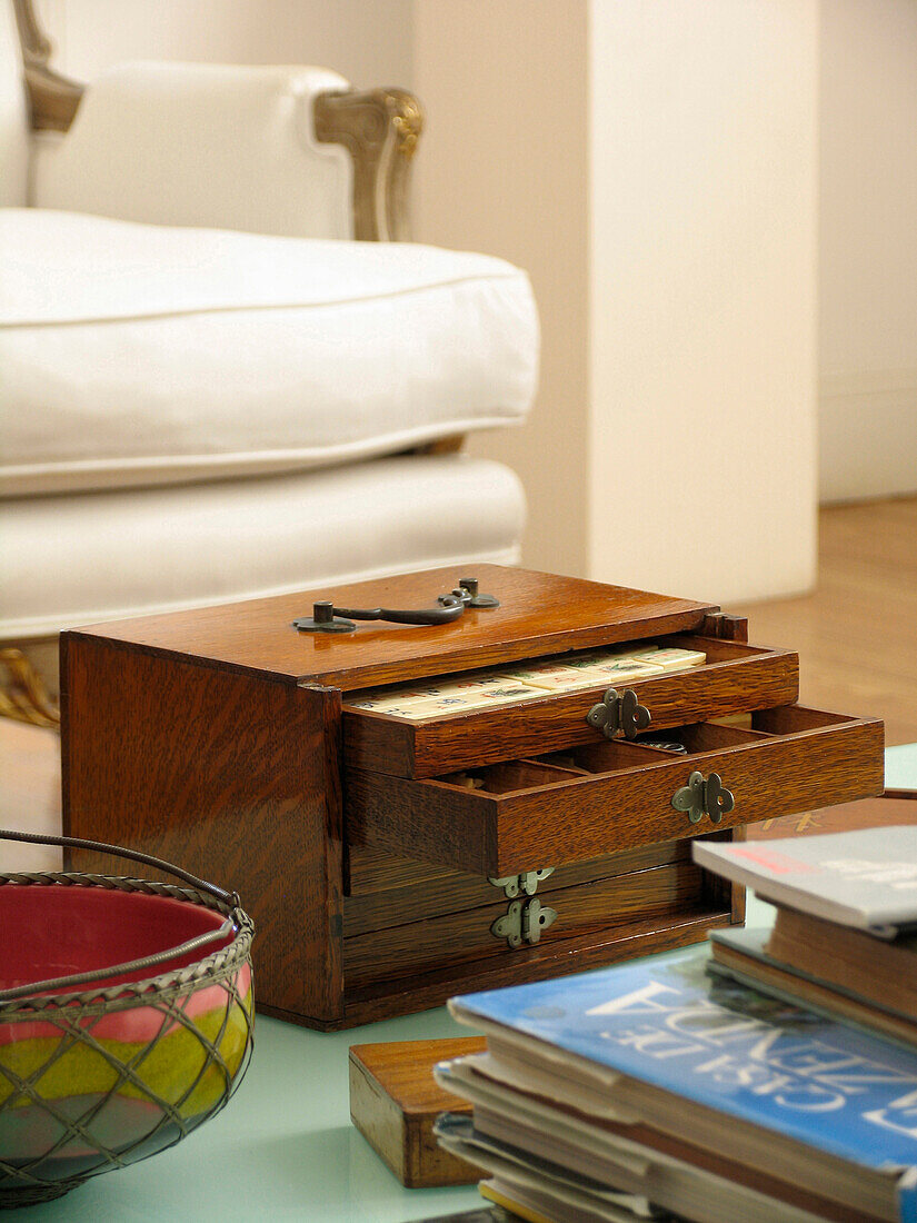 Wooden drawer unit and books on coffee table