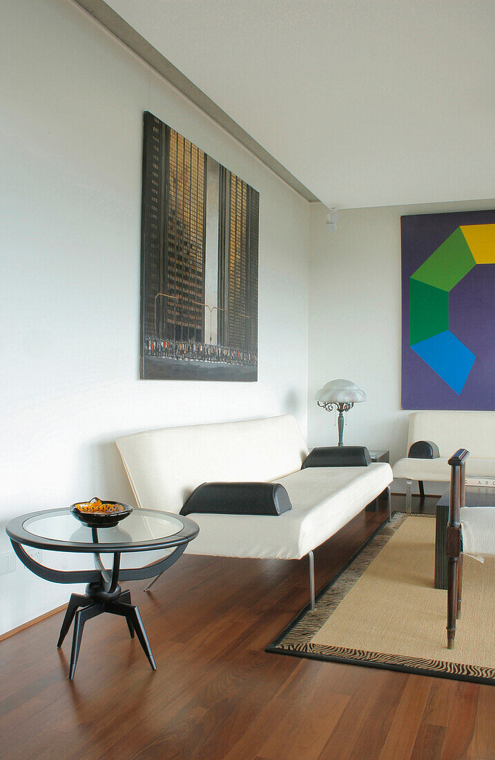 Seating area with modern art and polished wooden floor