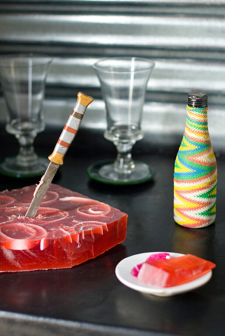 Strawberry soap antique knife and a bottle covered with electric cords of different colours