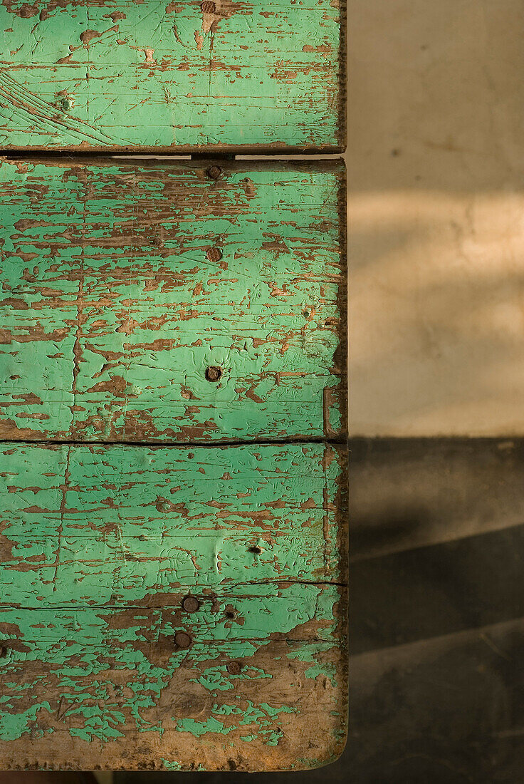 Weathered wooden tabletop with peeling paint