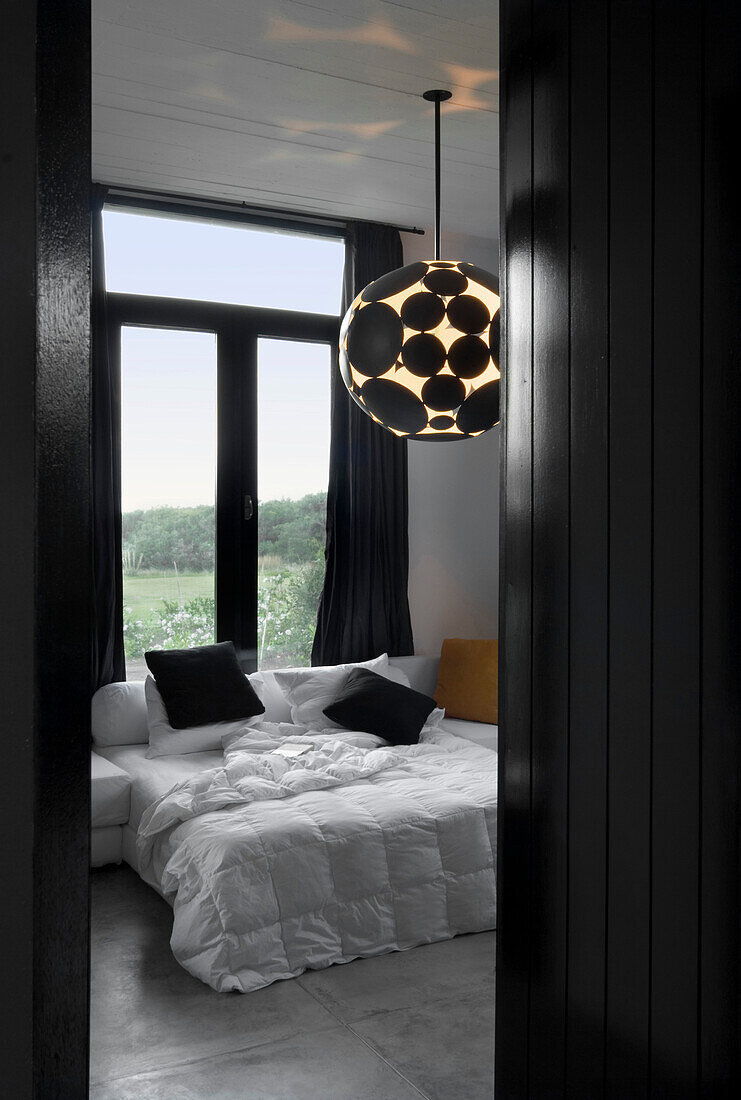 Avant-garde ceiling light in contrasting black and white bedroom