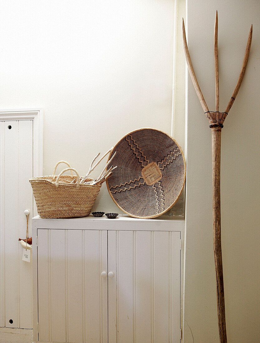 Hay pitch basket and bowl on white painted cupboard unit