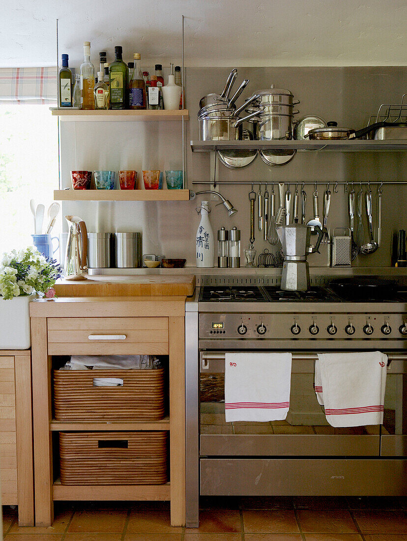 Stainless steel kitchen fittings and storage in 17th Century Oxfordshire house