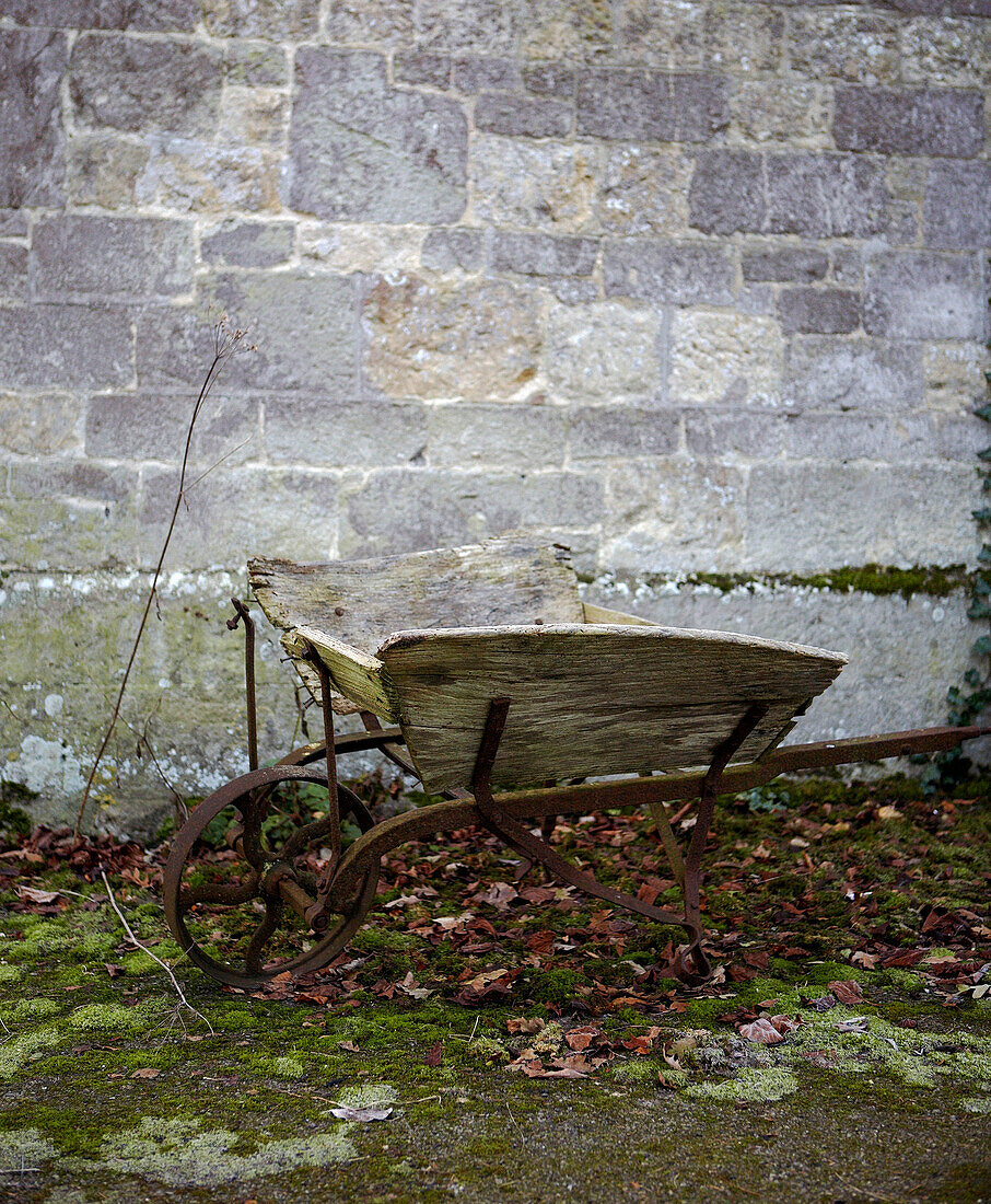 Rusty wheelbarrow in winter exterior of 1940s school house conversion