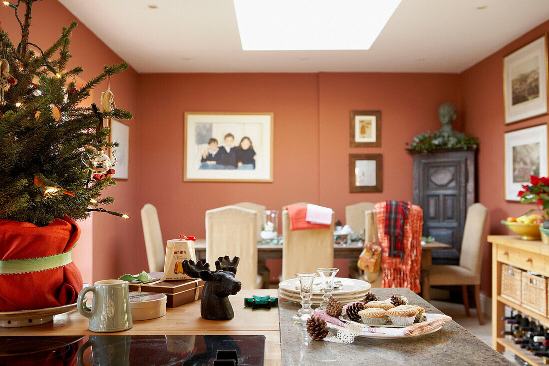 Christmas tree on kitchen worktop with mince pies and pine cones