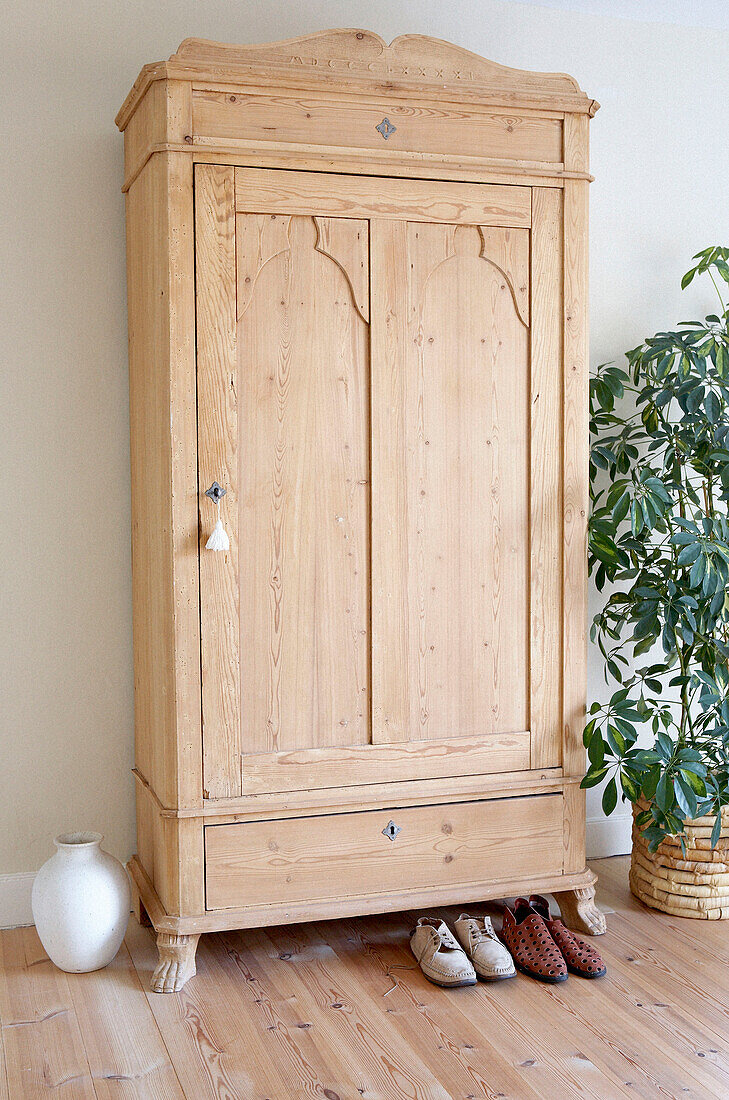 Schlafzimmerschrank aus hellem Holz und ein Paar Schuhe