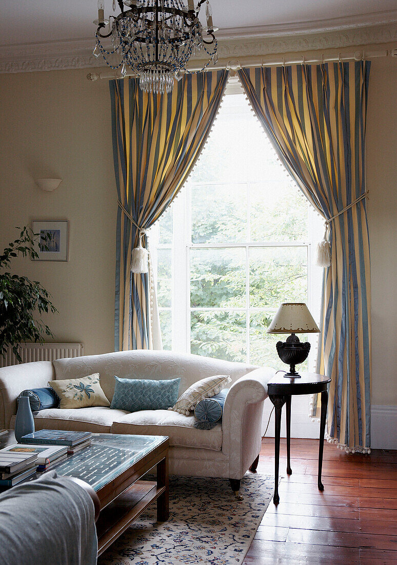 Striped curtains at window of Georgian townhouse living room 