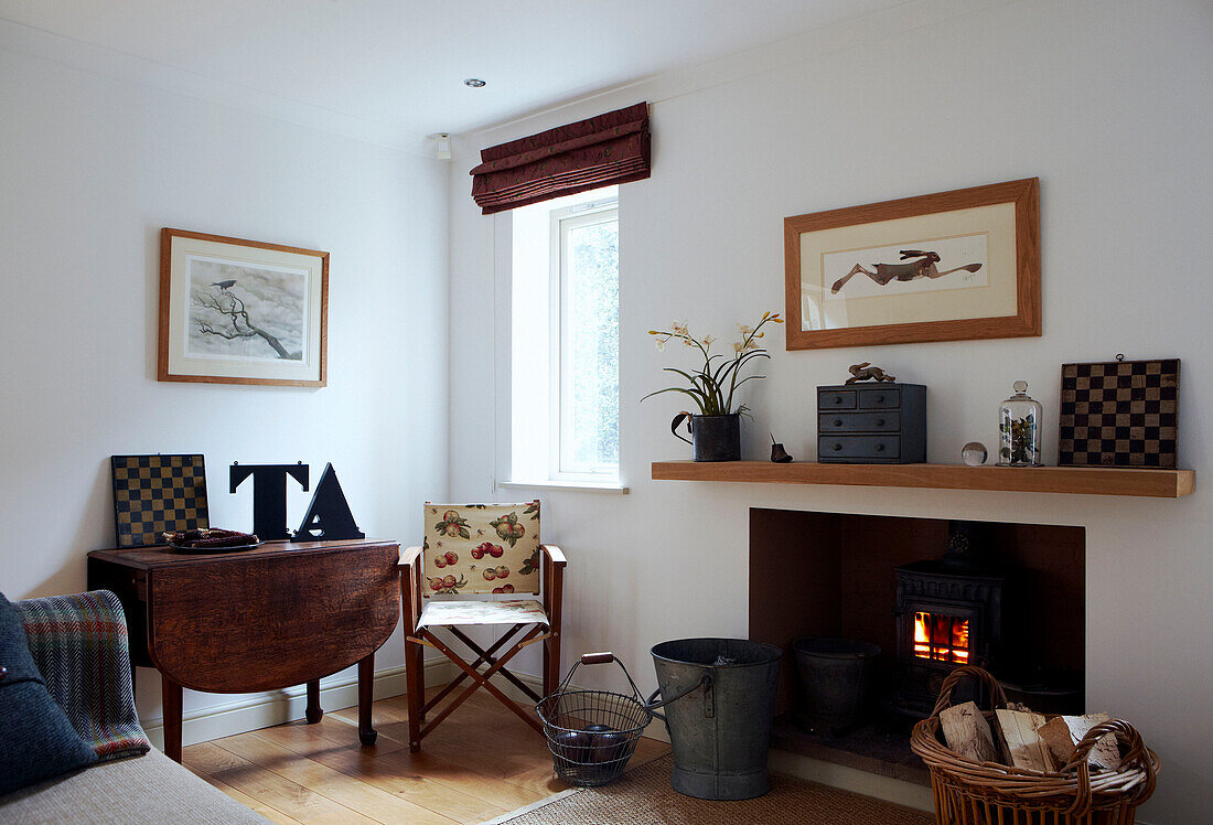 Shelf above wood burning stove and oversized letters on folding table