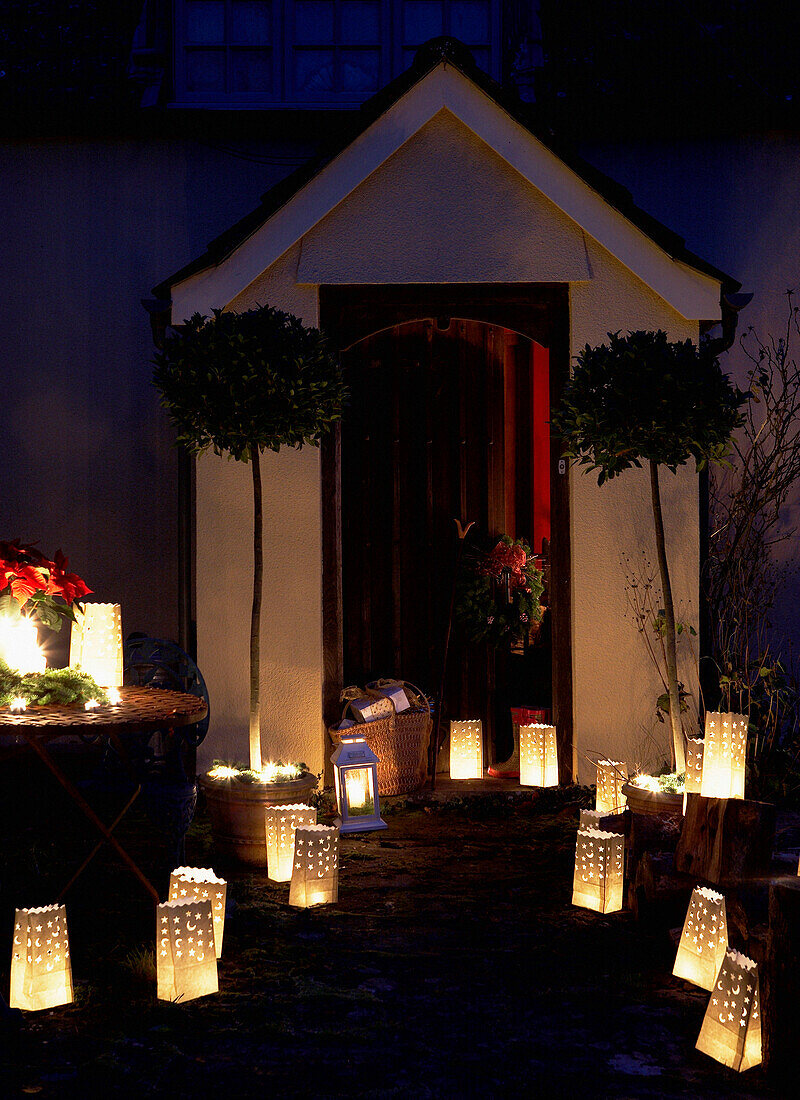 Lit lanterns at porchway of 16th Century Welsh farmhouse