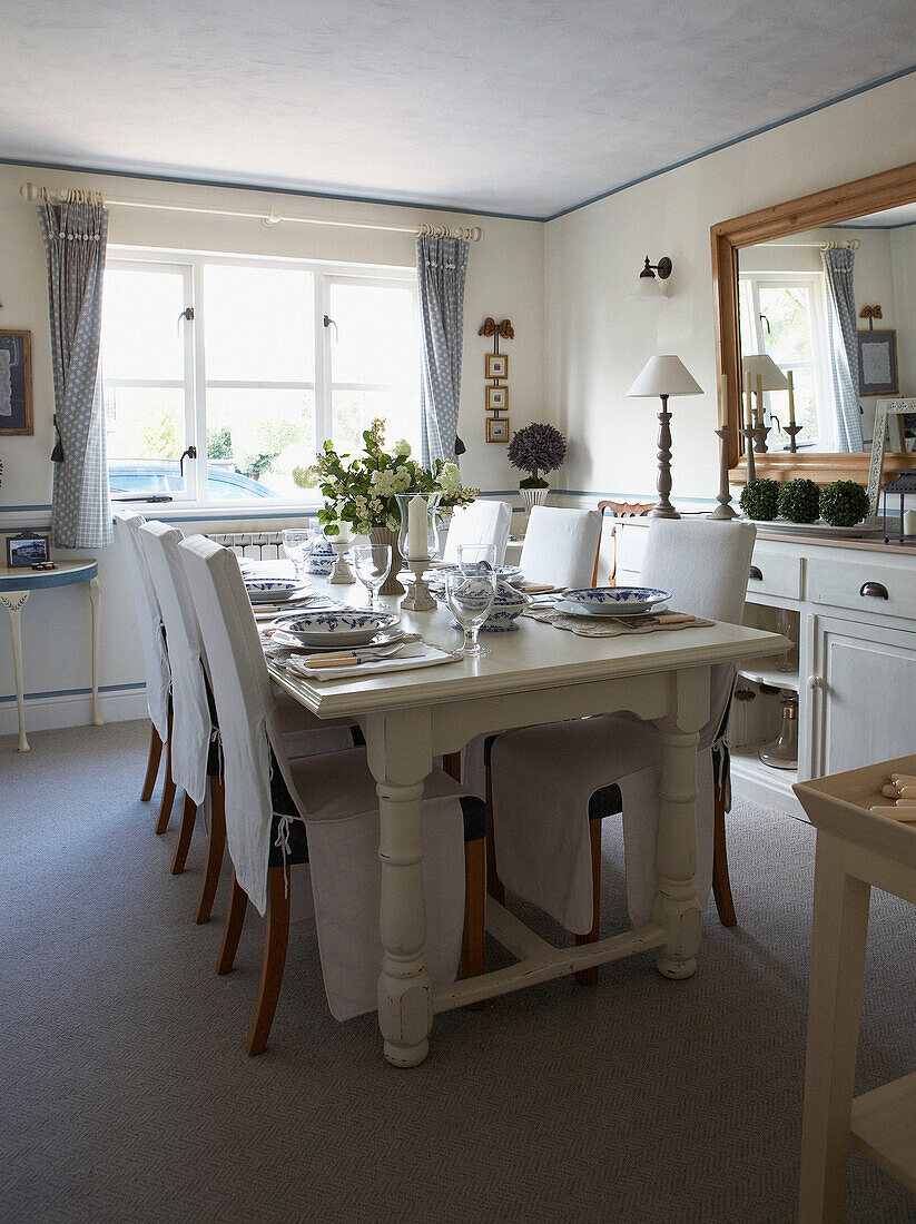 Set dining table in sunlit room with coir matting