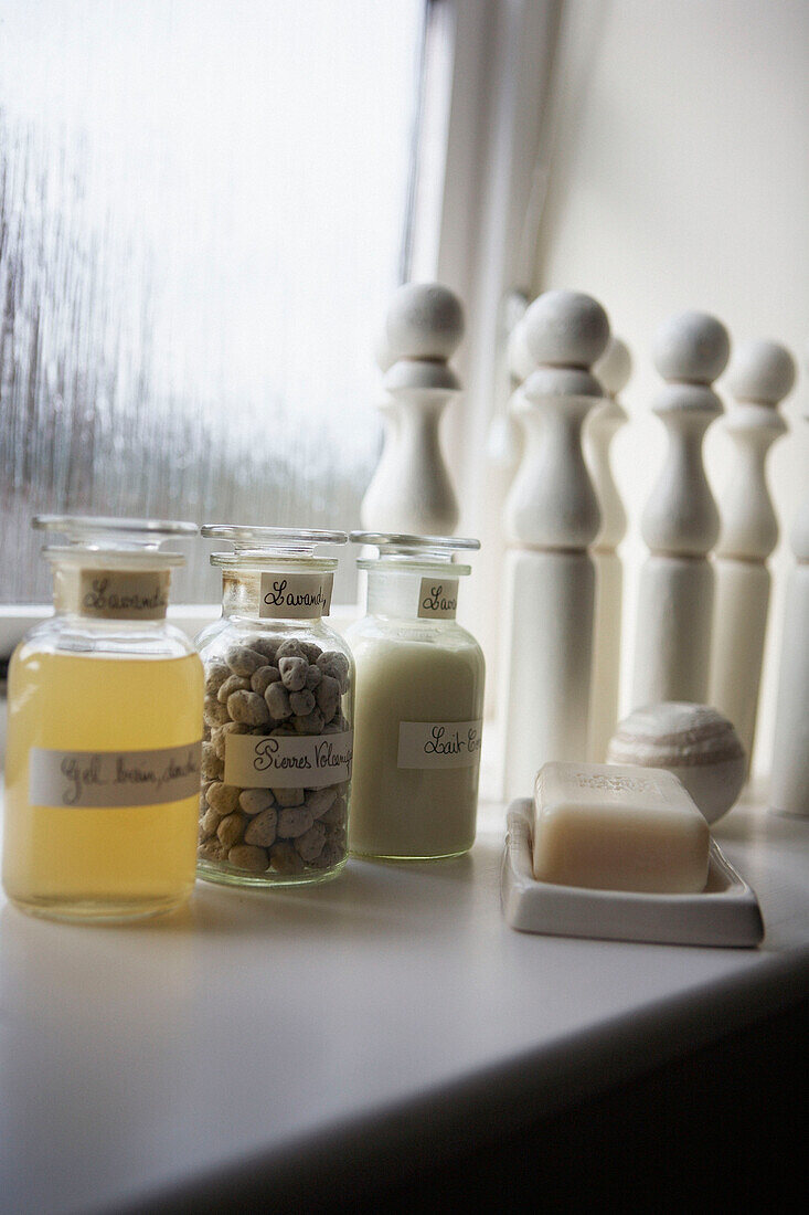 Scented toiletries and skittles on bathroom windowsill