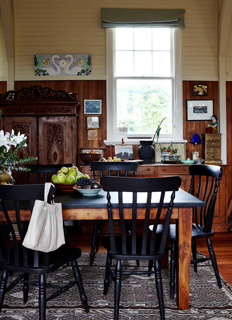 Black painted furniture in wood panelled kitchen Masterton New Zealand