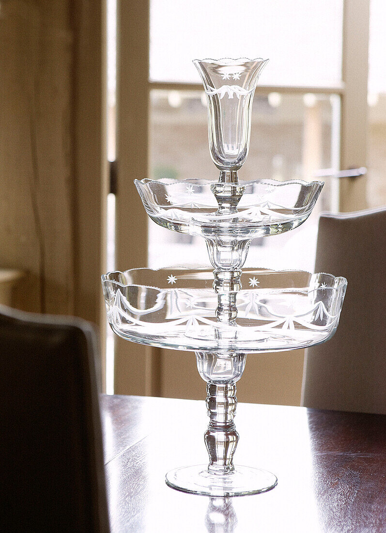 Glass cake stand on wooden tabletop