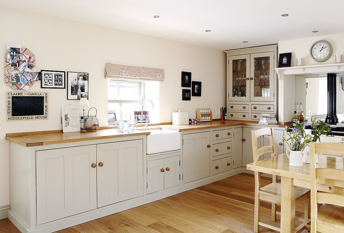 Fitted units and wooden worktop in contemporary family kitchen Durham England UK