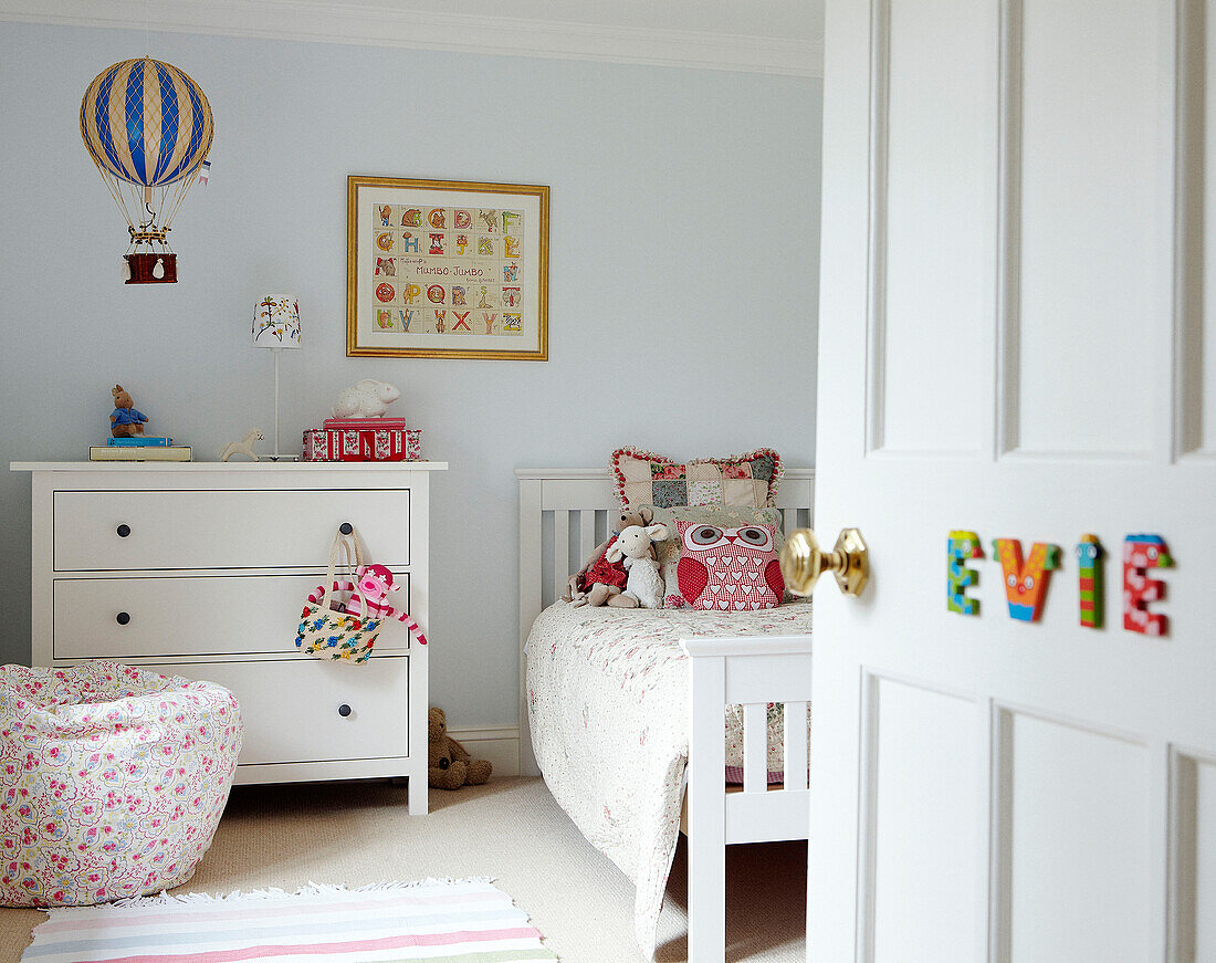 View through doorway to girls room in Oxfordshire home, England, UK