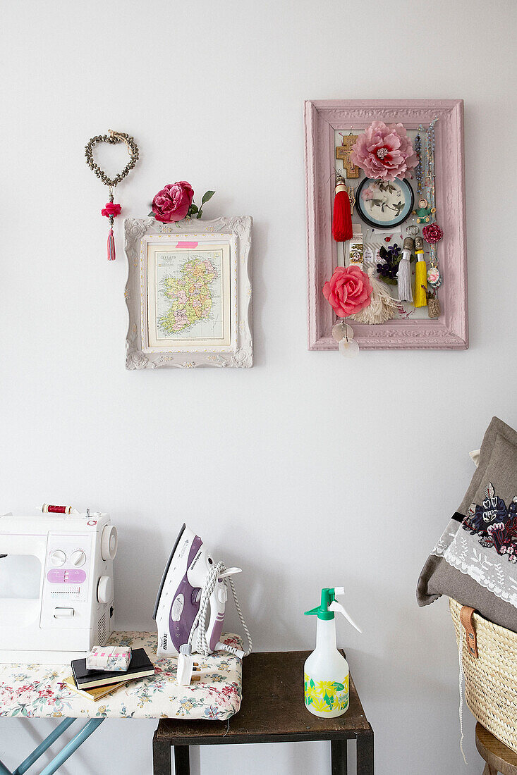 Display of scented objects above iron and sewing machine with water spray in contemporary home, Hastings, East Sussex, UK