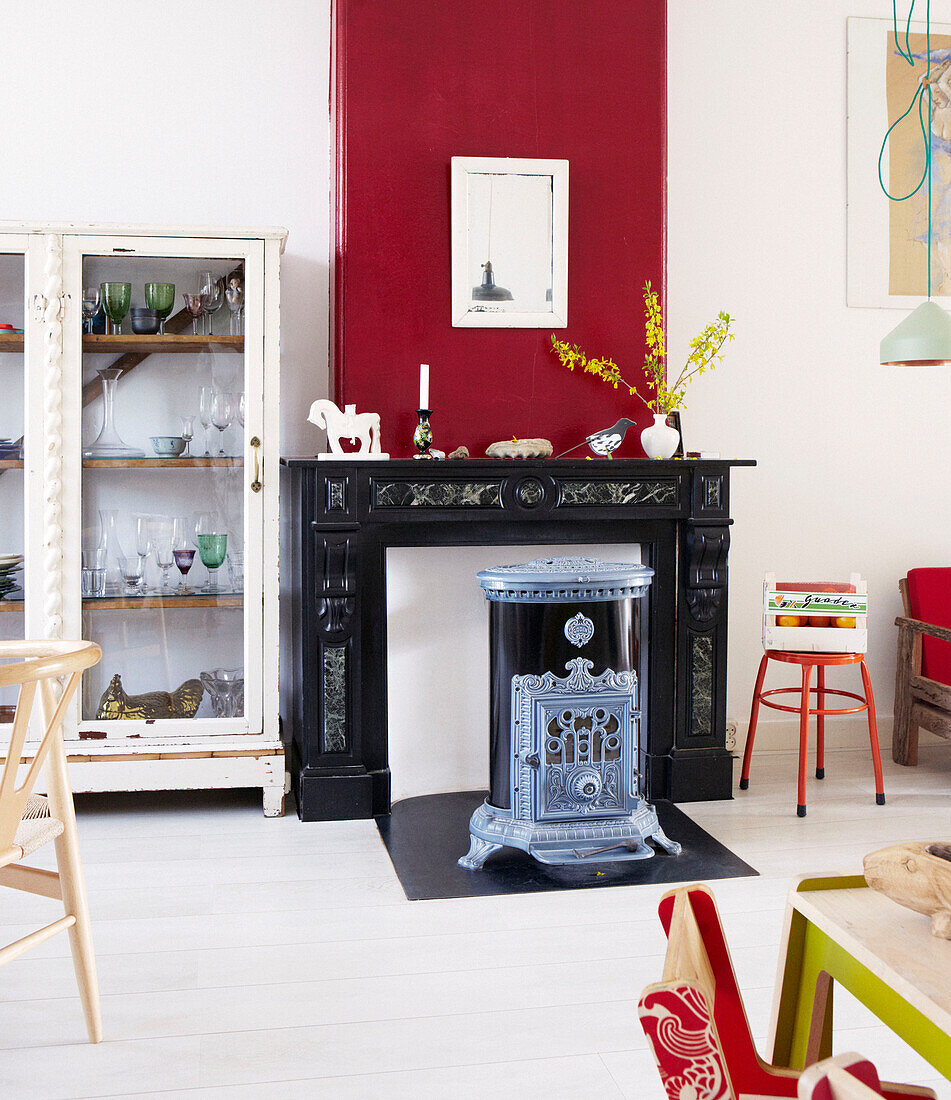 Antique stove in fireplace of contemporary apartment, Amsterdam, Netherlands