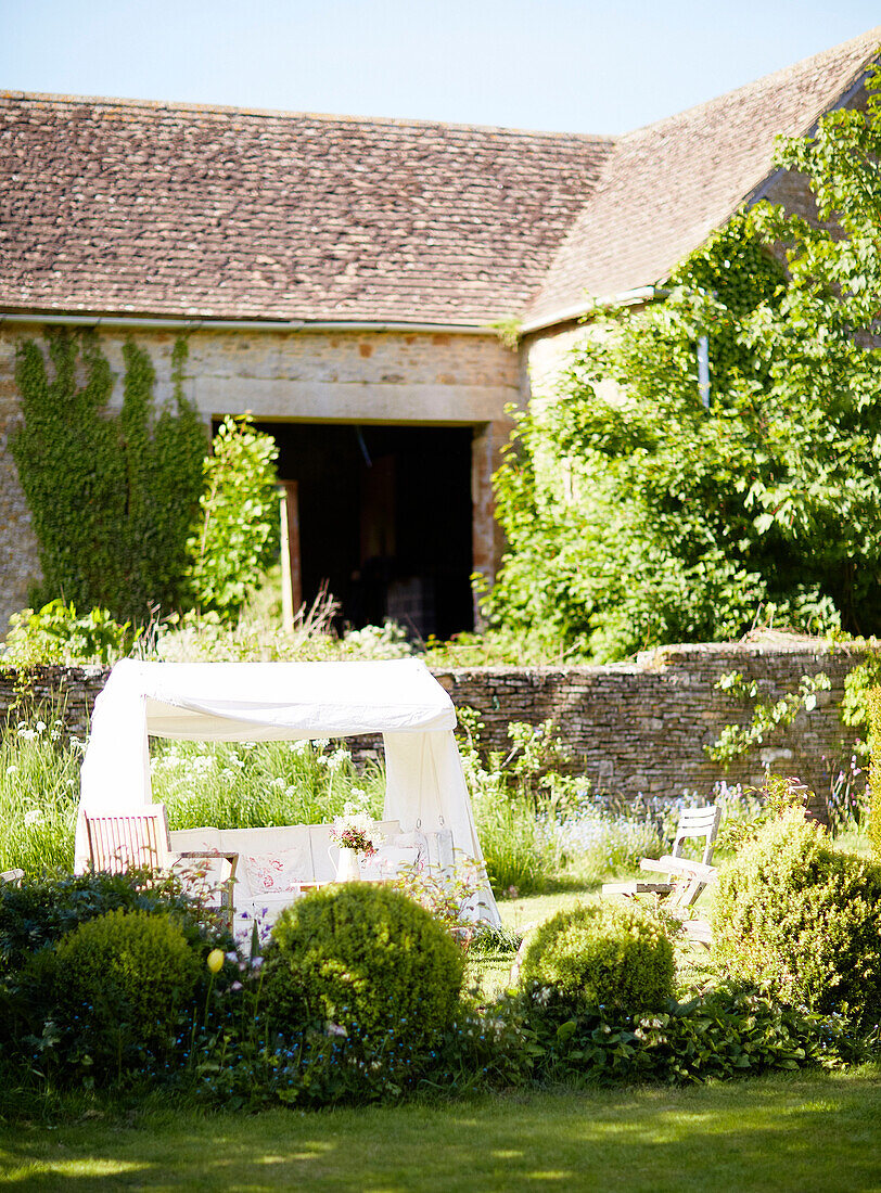 Shaded sunchair in grounds of Oxfordshire home England UK