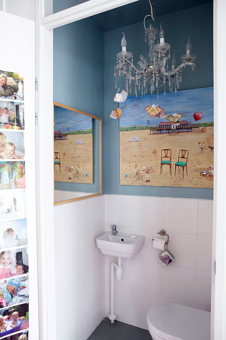 Chandelier and artwork in tiled bathroom of Mattenbiesstraat family home, Netherlands