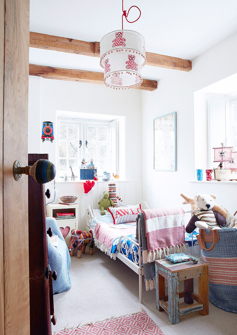 Single bed in beamed child's room of Devonshire country home UK