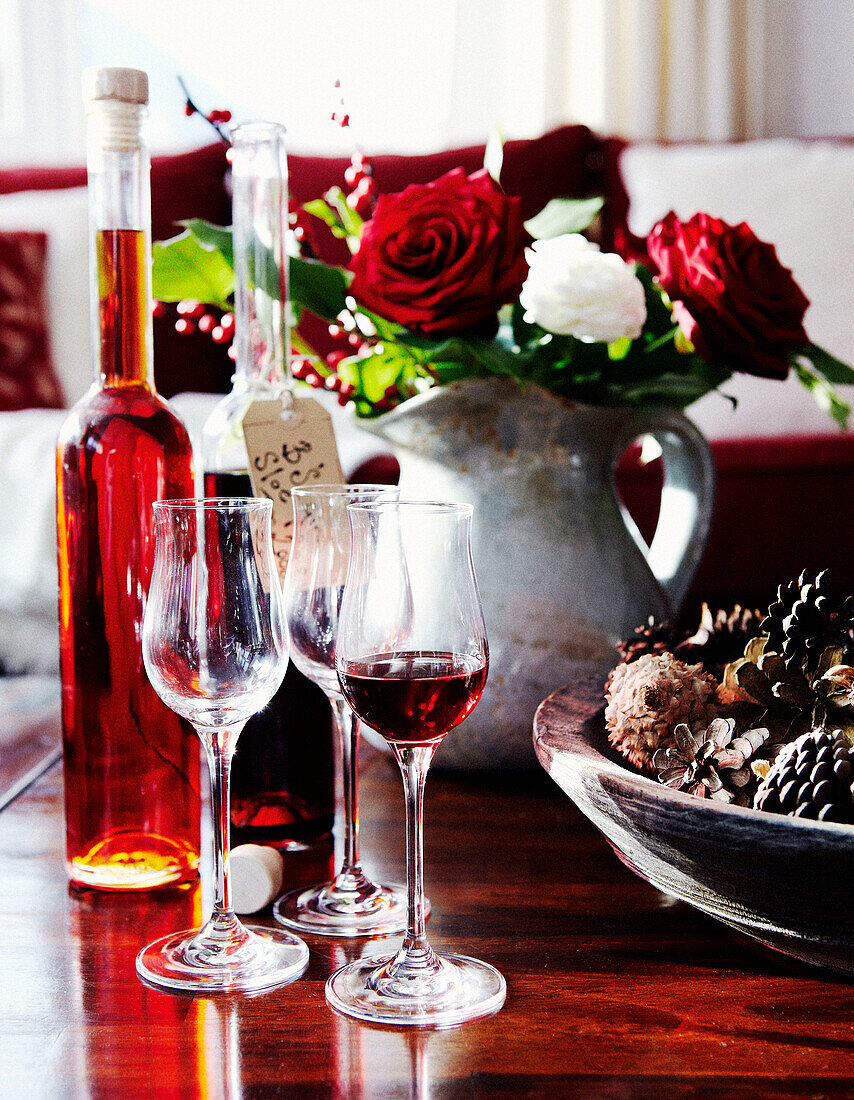 Wine glasses and sherry with cut flowers and pinecones in St Anton, Tyrol, Austria