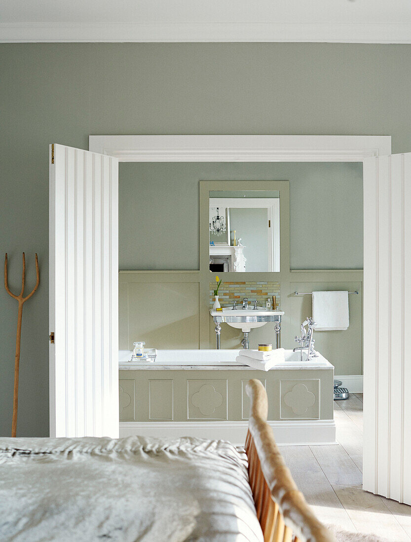 View through double doors to ensuite bathroom in Northumbrian manor house England UK