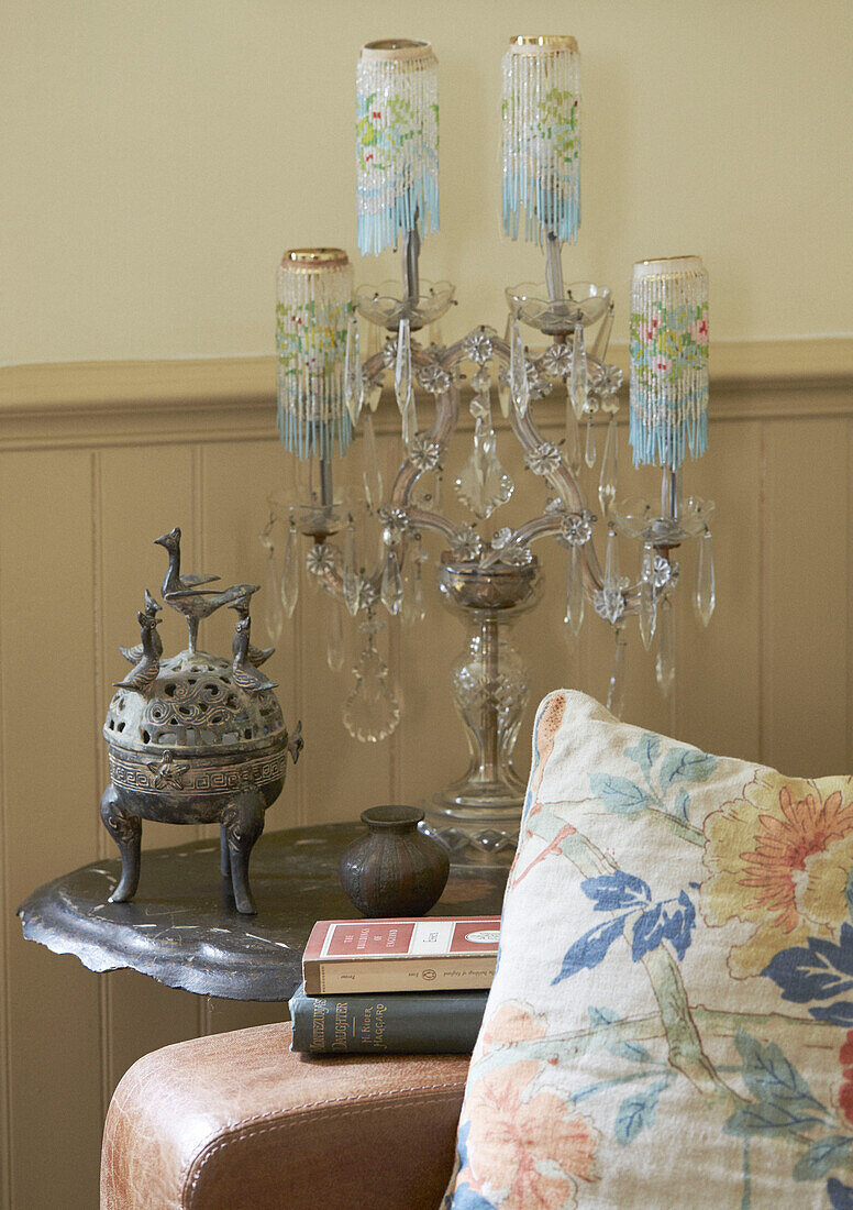 Metal incense holder and glass candle holder on side table in Whitley Bay cottage Tyne and Wear England UK