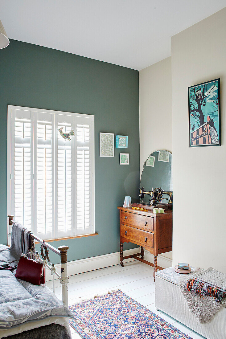 Vintage sewing machine on wooden sideboard at window in bedroom of Birmingham home England UK