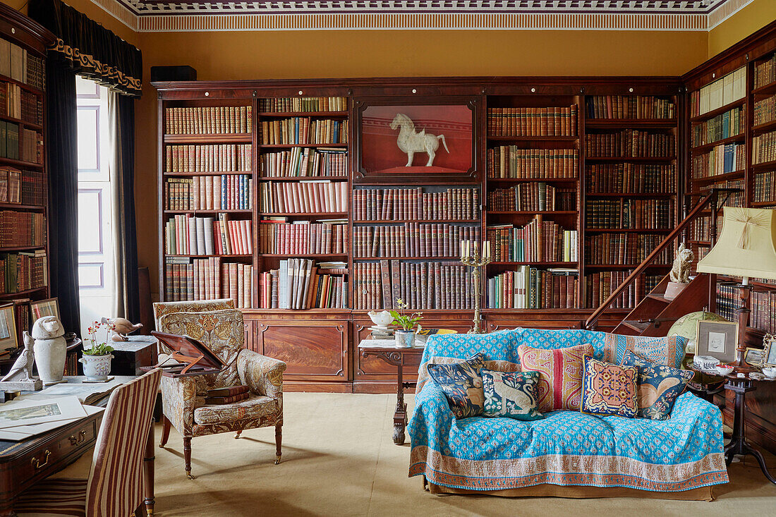 Quilted throw over sofa in library study of Capheaton Hall, Northumberland, UK