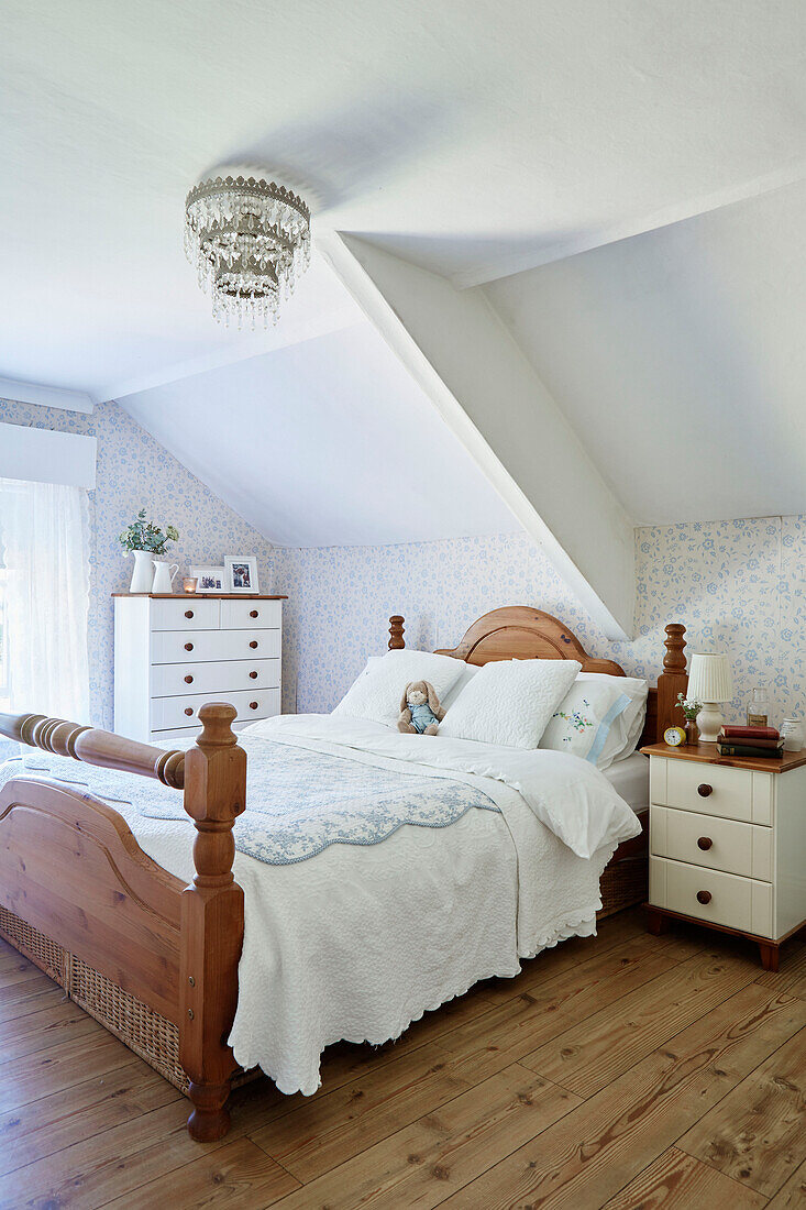 Carved wooden bed in attic bedroom of Northumberland cottage, Tyne and Wear, England, UK