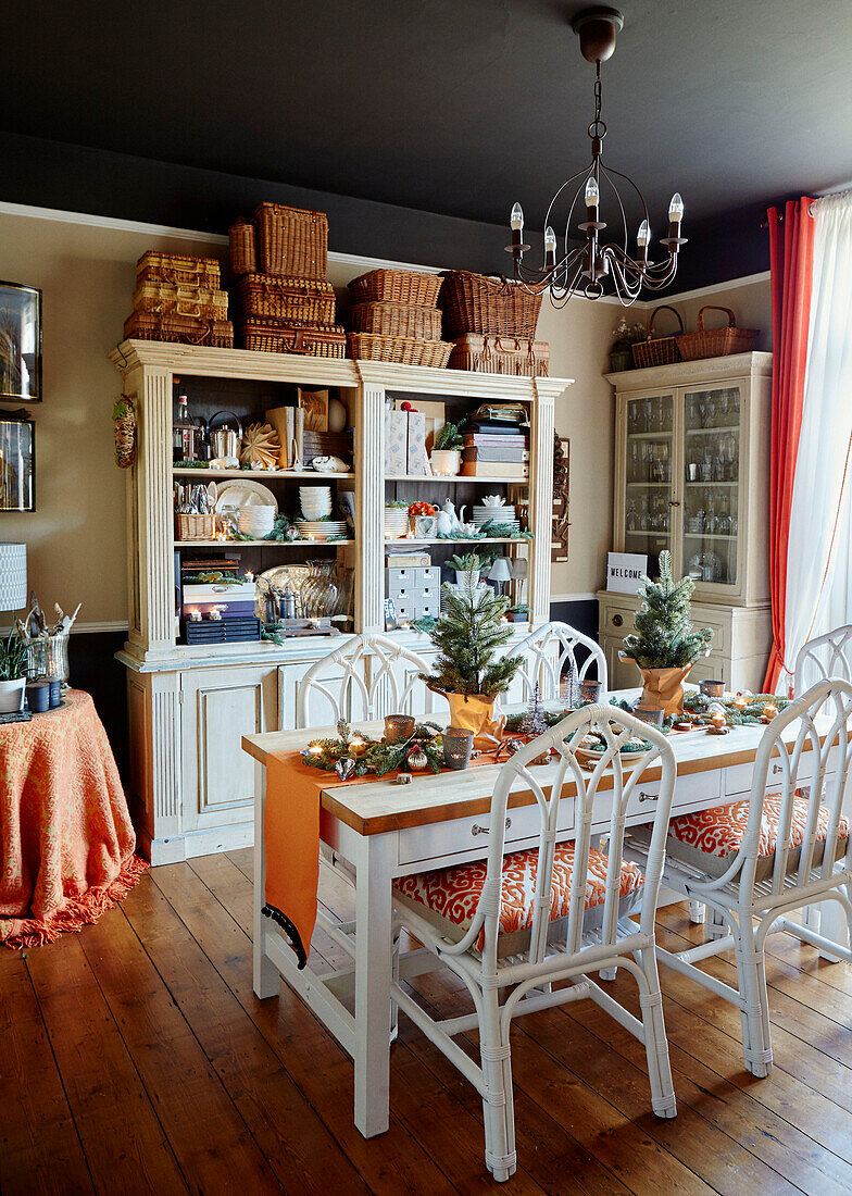 White dining chairs at table with glass-fronted dressers in Chippenham home, Wiltshire, UK