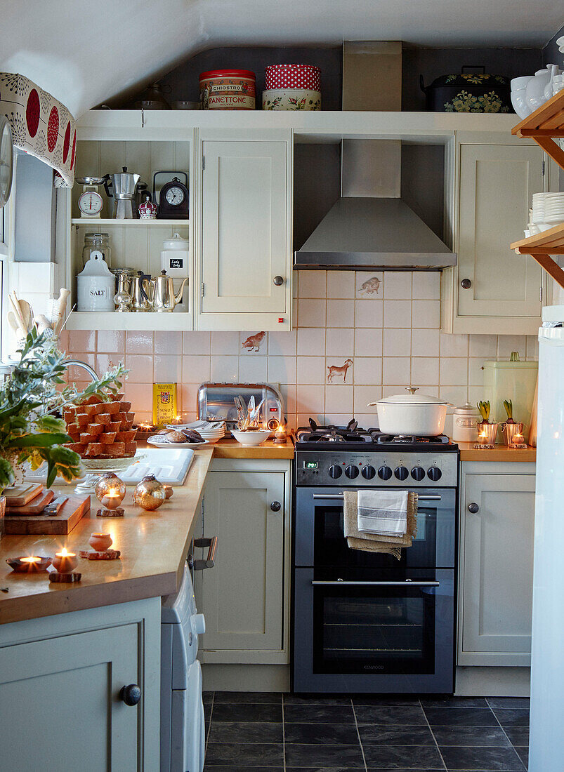 Fitted units and oven with lit tealights in Chippenham kitchen, Wiltshire, UK