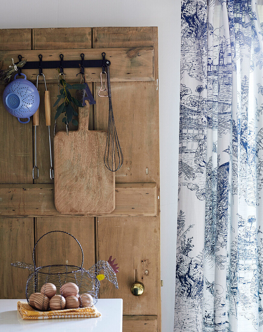 Egg basket and kitchenware with curtains in Warwickshire farmhouse, England, UK