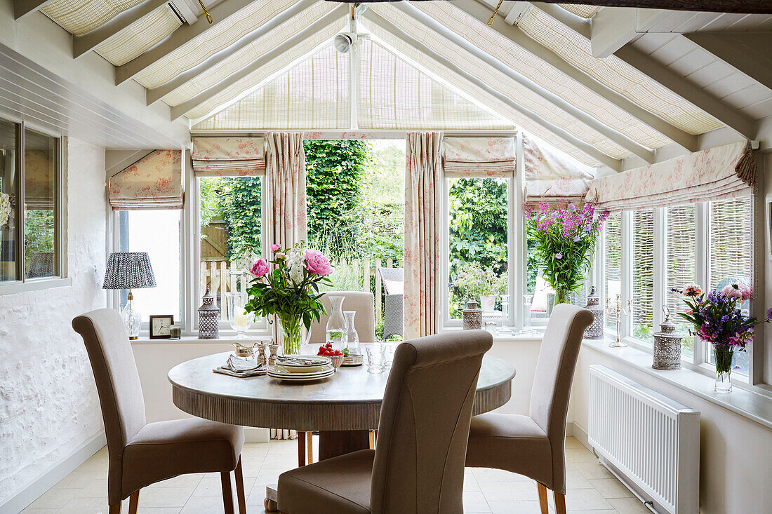 Circular dining table and chairs in Berkshire cottage, England, UK