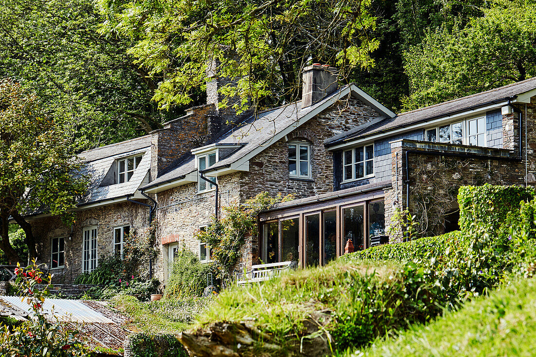 Detached stone house in Devon woodland, UK