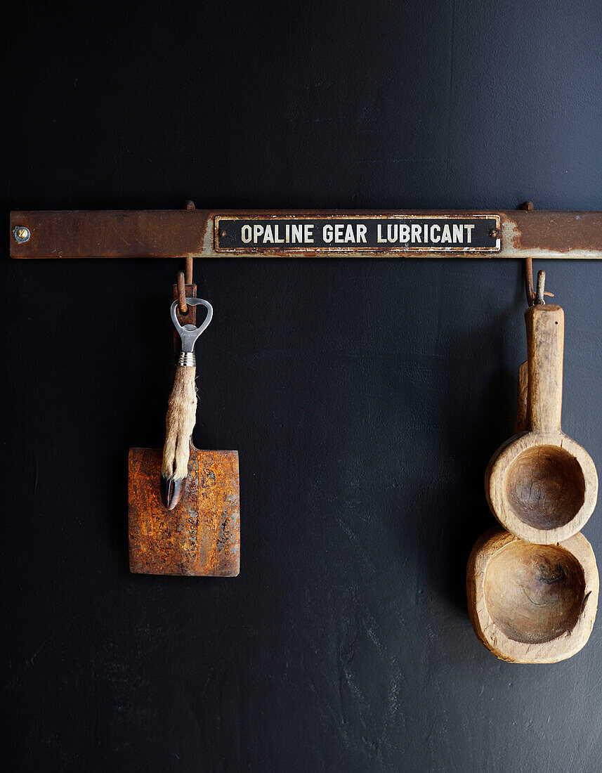 Animal foot bottle opener and wooden measuring spoons on metal hook in Ramsgate home Kent, UK