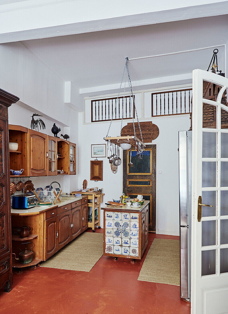 Wooden units in kitchen with painted floor in Foix, Ariege, France